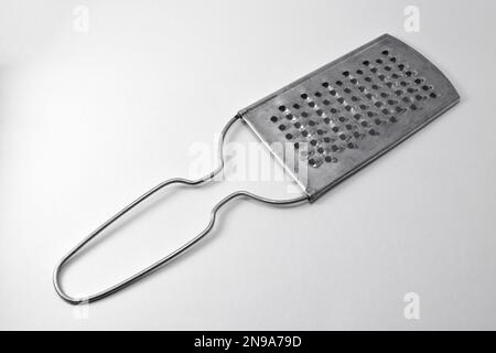 Premium Photo  Flat lay cheese grater stainless steel cheese grater with  pink handle white background lifestyle