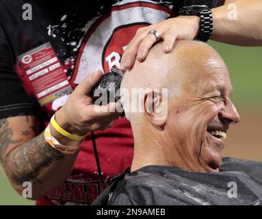 Cincinnati Reds broadcaster Marty Brennaman smiles as he has his