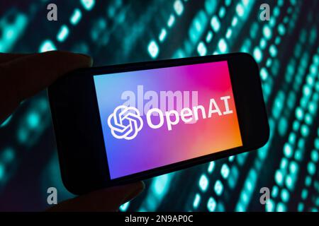 Digital composite of Microsoft ChatGPT OpenAI chatbot logo on phone screen Stock Photo