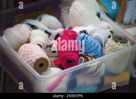 A set of different lace for needlework and sewing. Skeins of multicolored lace. Fringe or lace tapes and silk trimmings. Handmade cloth making Stock Photo