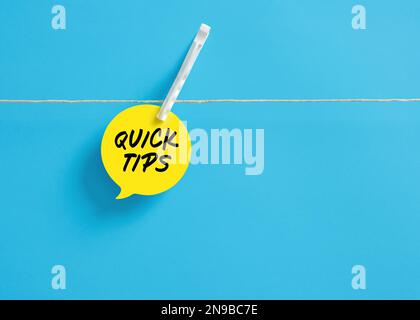 Quick tips on a speech bubble hanging on clothesline with a clothespin. Stock Photo