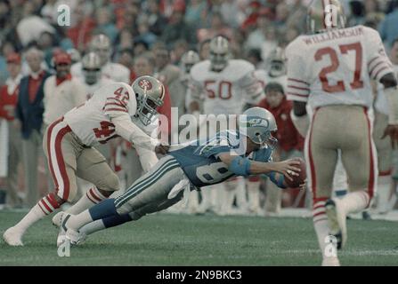 San Francisco 49ers Ronnie Lott pulls down Seattle Seahawks