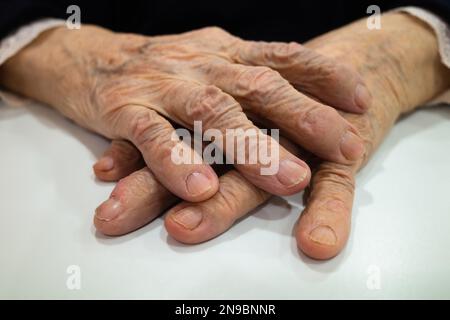 Close up of the crossed hands of an old wife Stock Photo