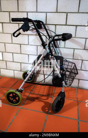 A rollator or walker is a mobile walking aid that consists of a support rod with wheels Stock Photo