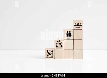 Soft skills training and improvement. Wooden cube staircase with the soft skills symbols; communication, collaboration, empathy and team spirit. Stock Photo
