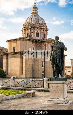 The statue of Julius Caesar in bronze at the place of his assassination in front of the Forum Iulium in Rome Stock Photo