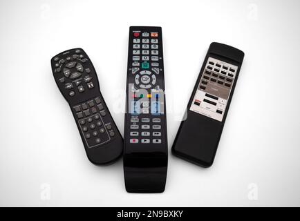 Various remote controls for TV and audio on white background Stock Photo