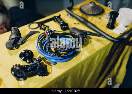 Bike assembling parts custom bicycle in workshop table Stock Photo