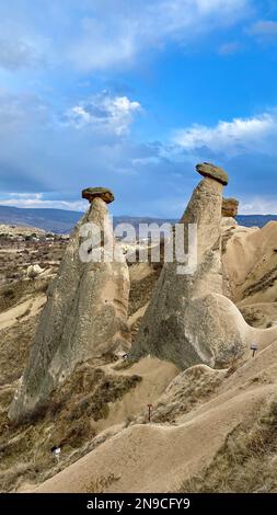 Three Graces, three Beautifuls (uc guzeller) rock hills in Devrent valley, Cappadocia, Nevsehir,  Turkey Stock Photo