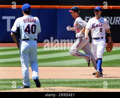 The ball sails past the outstretched glove of New York Mets third baseman David  Wright as Houston Astros Adam Everett, right, slides safely in after  stealing second and taking third on an