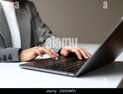 Female hands and laptop close-up, business person working on laptop. Stock Photo