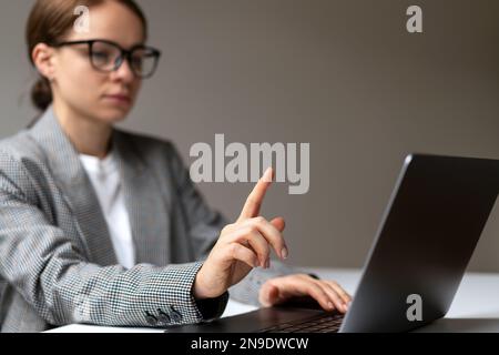 Defocused woman in background touching with her finger virtual display mockup template. Stock Photo
