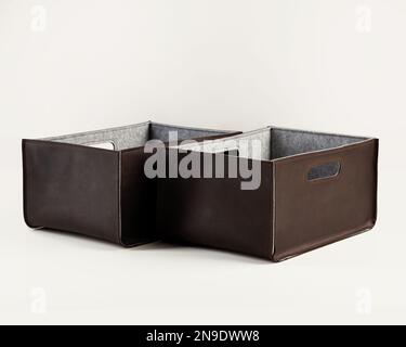 Two handcrafted brown faux leather storage boxes Stock Photo