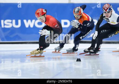 Dordrecht, Netherlands. 12th Feb, 2023. Lin Xiaojun (L) of China competes during the semifinal of men's 500m at the ISU World Cup Short Track Speed Skating series in Dordrecht, the Netherlands, Feb. 12, 2023. Credit: Zheng Huansong/Xinhua/Alamy Live News Stock Photo