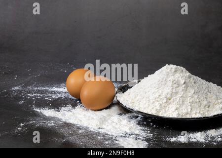 All-purpose flour and eggs are common ingredients used in many recipes, including baked goods such as cakes, bread, and pastries. Stock Photo