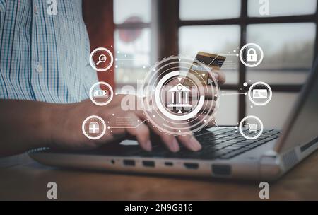 Businessman holding credit card to using laptop financial transactions and online shopping with technology icons digital banking, internet payment and Stock Photo