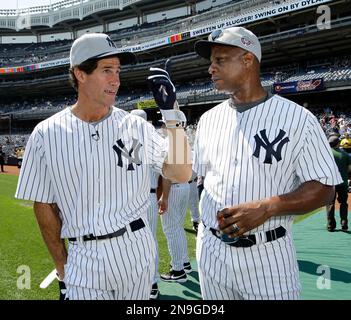 Former New York Yankees outfielders Bernie Williams (51), and Paul O'Neill,  right, greet each other at the Yankees 67th annual Old Timers Day baseball  game Sunday, June 23, 2013, in New York. (