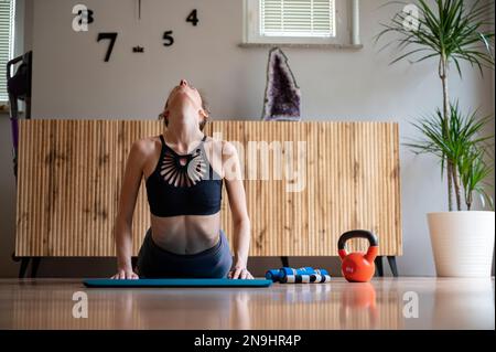woman making yoga low angle lunge pose on mat Stock Photo - Alamy