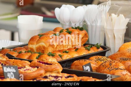 Stand with fresh sweet and savoury pastries on display at the Náplavka Farmers' Market in winter at the beginning of the new season. Stock Photo