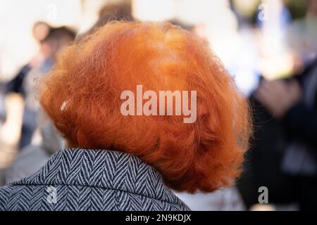 Red dyed hair of an elderly woman taken from behind Stock Photo