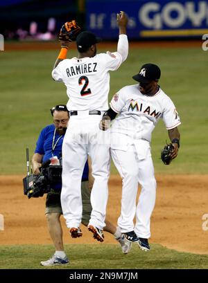 Miami Marlins Jose Reyes motions his team mates after sliding into second  base against the New York Yankees at the new Miami Marlins Ball Park in the  second exhibition game April 2