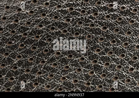 Shiny perforated grid background macro close up view Stock Photo