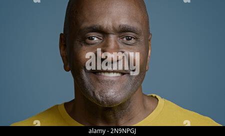 Male portrait mature african american man looking camera smiling with white toothy smile joyful ethnic senior male athlete satisfied client happy with Stock Photo