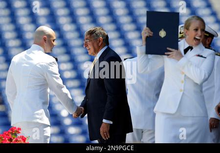 Secretary of Defense Leon Panetta, center, shakes hands with a United States Naval Academy Midshipmen as a fellow Midshipman, right, reacts after receiving her diploma during the Academy's graduation and commissioning ceremonies in Annapolis, Md., Tuesday, May 29, 2012. The Pentagon chief said Tuesday building U.S. maritime strength across the Asia-Pacific region will be one of the main projects for the new generation of America's naval officers. (AP Photo/Patrick Semansky)