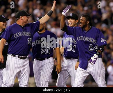 Colorado Rockies' Jason Giambi, left, is congratulated by teammate Troy  Tulowitzki after hitting a three-run home run off Kansas City Royals  starting pitcher Zack Greinke during third inning of a baseball game