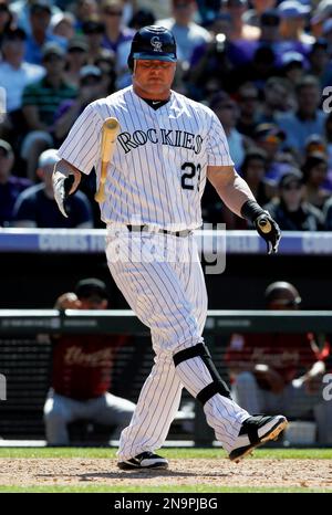 Colorado Rockies pinch hitter Jason Giambi (23) high fives teammate Todd  Helton after scoring against the Philadelphia Phillies in the eighth inning  during game four of the National League Divisional Series at