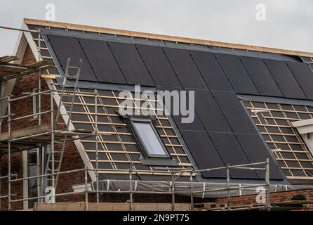 New house under construction with solar panels already installed on the roof Stock Photo