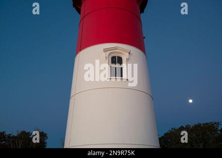 Detail of the Nauset Light at night with a full moon in the clear sky in the background; Eastham, Cape Cod, Massachusetts, United States of America Stock Photo