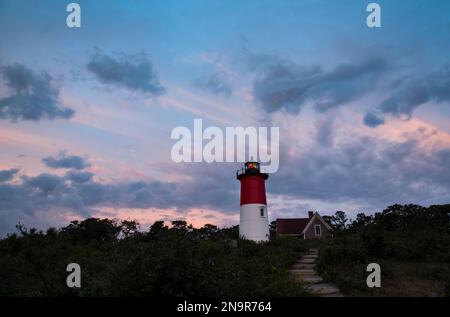 Nauset Light at twilight with glowing clouds above; Eastham, Cape Cod, Massachusetts, United States of America Stock Photo