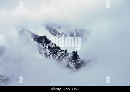 mountain ridge snow covered and clouds in Sicily, slope of the "Valle del Bove" in Etna National Park, Italy Stock Photo