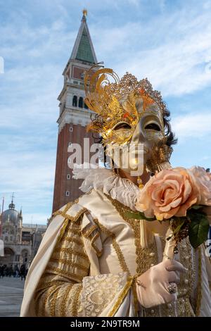 Masked revellers pose in St Mark's Square on February 20, 2022 in ...