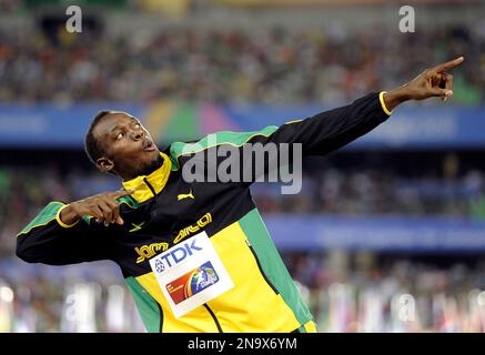 file this sept 4 2011 file photo shows jamaicas usain bolt posing on the podium after the jamaican team won the gold and set a new world record in the mens 4x100m relay final at the world athletics championships in daegu south korea the international track and field federation is looking for the best impression of the olympic sprint champions to di world pose in which he leans back and points both his index fingers skyward ap photomartin meissner file