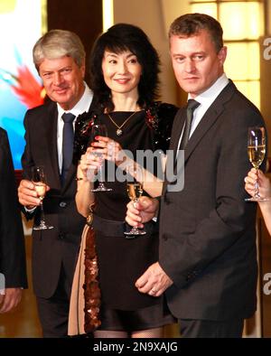 TOKYO, Japan - Yves Carcelle (C), chairman and CEO of Louis Vuitton  Malletier, joins hands with Kyojiro Hata (L), outgoing president of Louis  Vuitton Japan and Kiyotaka Fujii, next LVJ president, during