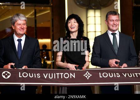 TOKYO, Japan - Yves Carcelle (C), chairman and CEO of Louis Vuitton  Malletier, joins hands with Kyojiro Hata (L), outgoing president of Louis  Vuitton Japan and Kiyotaka Fujii, next LVJ president, during