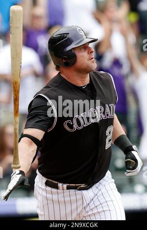 Colorado Rockies pinch hitter Jason Giambi (23) high fives teammate Todd  Helton after scoring against the Philadelphia Phillies in the eighth inning  during game four of the National League Divisional Series at