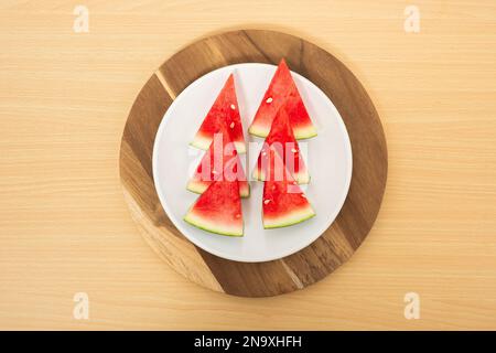 Fresh ripe tasty sliced watermelon on a wood table background Stock Photo
