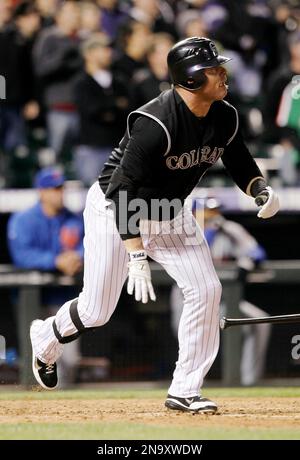 Colorado Rockies pinch hitter Jason Giambi (23) high fives teammate Todd  Helton after scoring against the Philadelphia Phillies in the eighth inning  during game four of the National League Divisional Series at