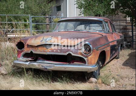 An old Desoto Firedome Entry Level Series 1956 abandoned and rusting in the courtyard Stock Photo