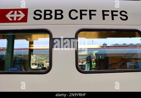 Reflections in the windows of InterRegio train at Aigle railway station Stock Photo