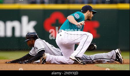 Seattle Mariners' Dustin Ackley safely dives back to first base after a  pick-off attempt in the fifth inning of a baseball game against the Detroit  Tigers, Sunday, June 1, 2014, in Seattle. (