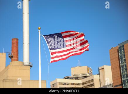 US flag waving in the wind public in the city Stock Photo