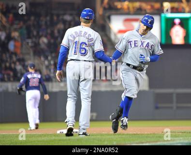 Texas Rangers' Ian Kinsler, right, walks off the field with Rangers manager  Ron Washington, left, after Kinsler's two home runs led the Rangers to a  5-1 win over the Seattle Mariners in