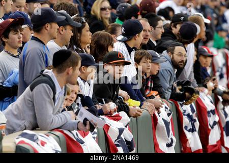 New York Yankees fans look on dejected as Florida Marlins pitcher Josh  Beckett leaps in the air after making the final out to win game 6 against  the Yankees and the 2003