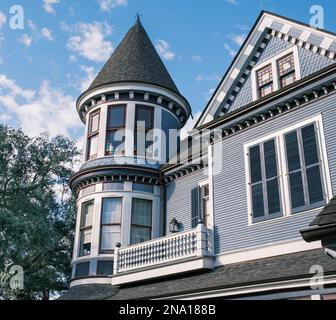 NEW ORLEANS, LA, USA - FEBRUARY 7, 2023: Turret and balcony section of historic Victorian Queen Anne style home facing Audubon Park Stock Photo