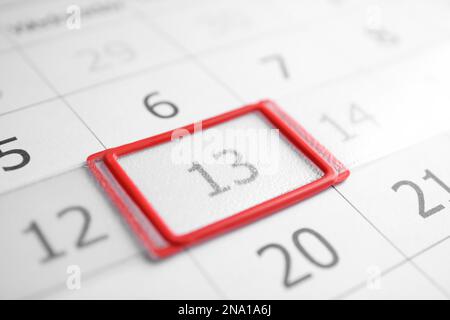 Closeup view of calendar page, focus on Friday 13. Bad luck superstition Stock Photo