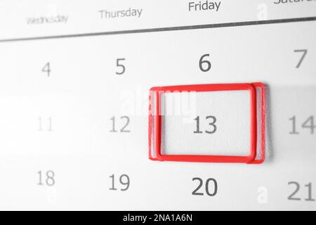 Closeup view of calendar page, focus on Friday 13. Bad luck superstition Stock Photo